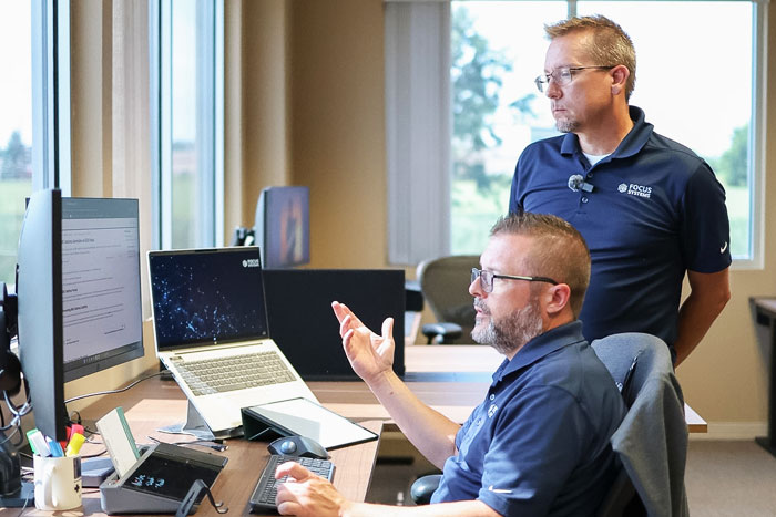Two Team Members Discussing Solutions