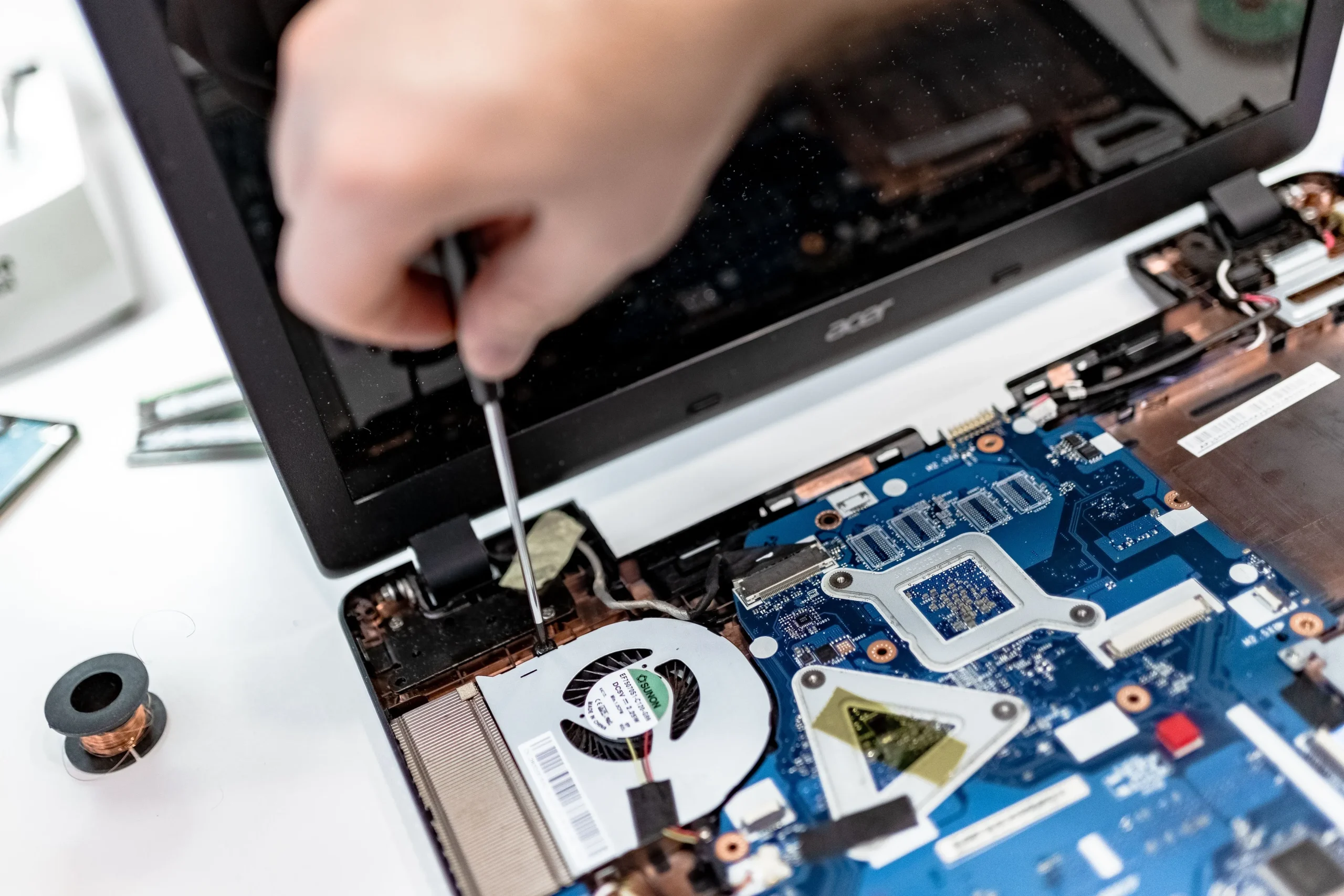 Using a screwdriver to fix a laptop